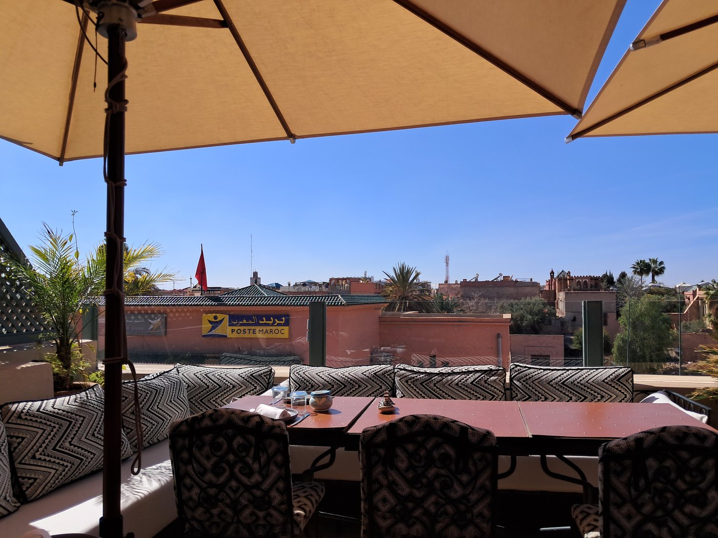 The rooftop of the Moroccan Culinary Arts Museum, Marrakech — mint tea, a parasol, and a view over the medina